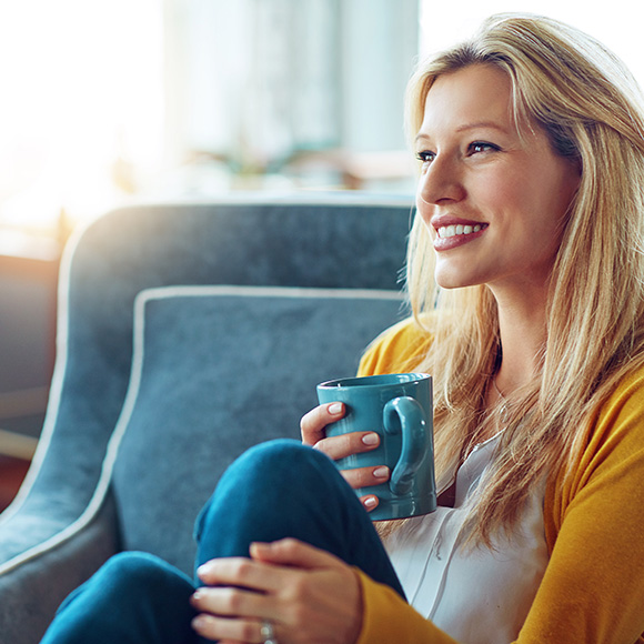 Happy woman drinking coffee to promote household insurance broker Full-time Cover