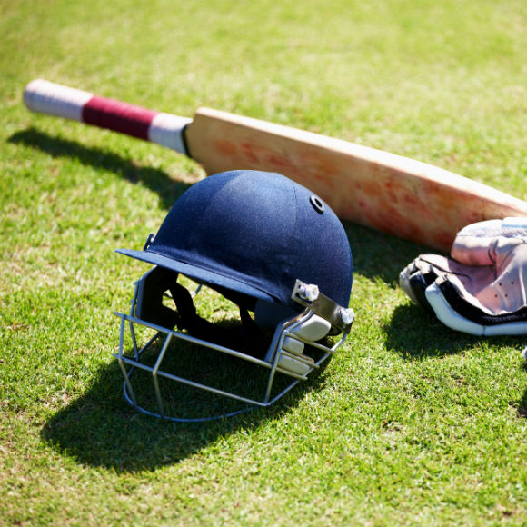 Cricket equipment on field to promote leading cricket insurance brokers Full Time Cover
