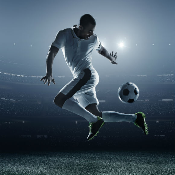 Stylized image of footballer managing ball on pitch to promote leading football insurance brokers Full-Time Cover