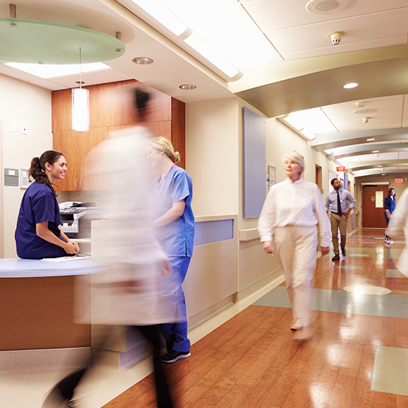 Blurred health professionals in corridors to promote leading health and life insurance brokers Full Time Cover