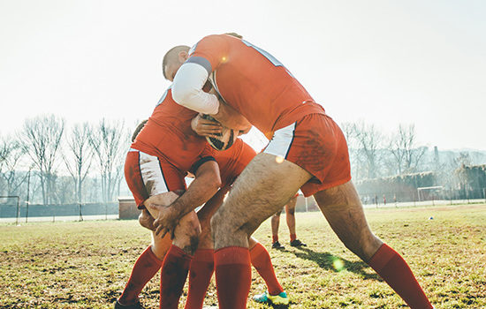 Rugby players in a huddle to promote leading rugby insurance broker Full-time Cover