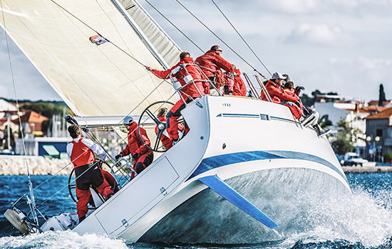 Group working on yacht before race to promote leading yacht insurance broker Full-time Cover