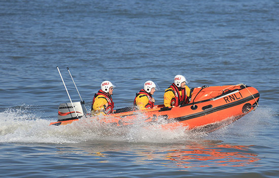 RNLI staff on a boat to promote Full Time Cover's Team Activity TopUp Insurance