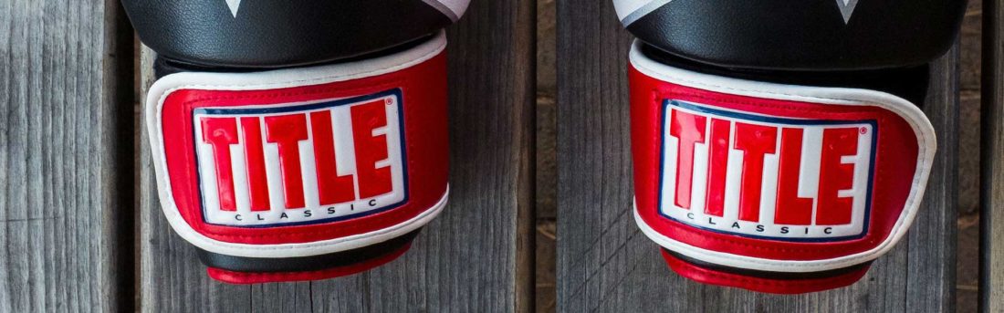 A pair of boxing gloves on a slated wood background to promote leading boxing insurance brokers full time cover